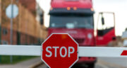 truck-standing-at-the-barrier-with-a-stop-sign-2022-08-01-04-29-41-utc